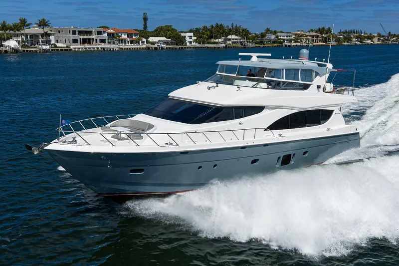 Slide: The Image of 2013 Hatteras 80 Motor Yacht cruising on a sunny day near waterfront homes. - 79