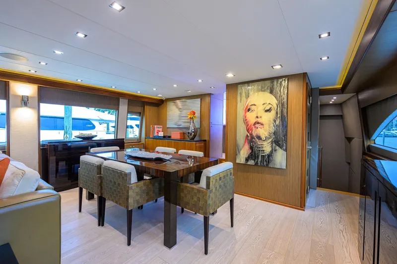 Slide: The Image of Luxurious interior of 2013 Hatteras 80 Motor Yacht with modern dining area and artwork. - 8