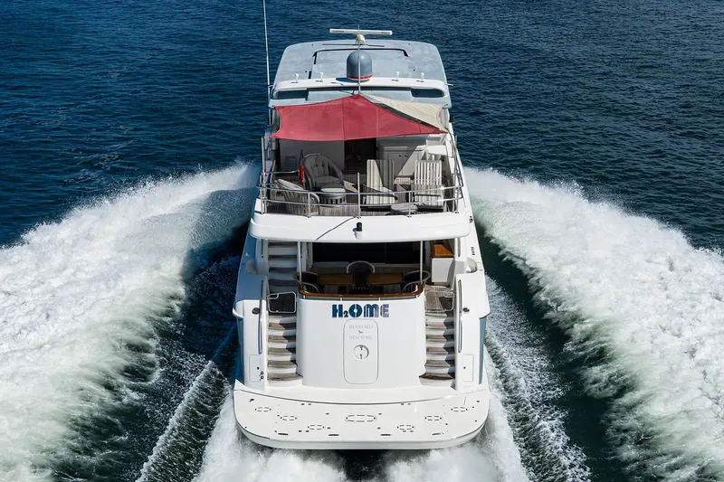 Slide: The Image of 2013 Hatteras 80 Motor Yacht cruising on open water, rear view. - 83