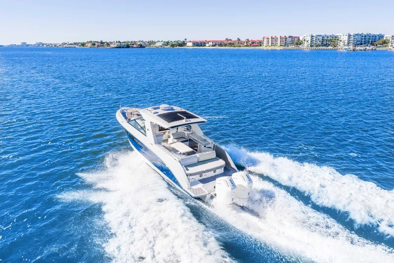 Slide: The Image of 2023 Sea Ray SLX 400 Outboard cruising on open blue water. - 11