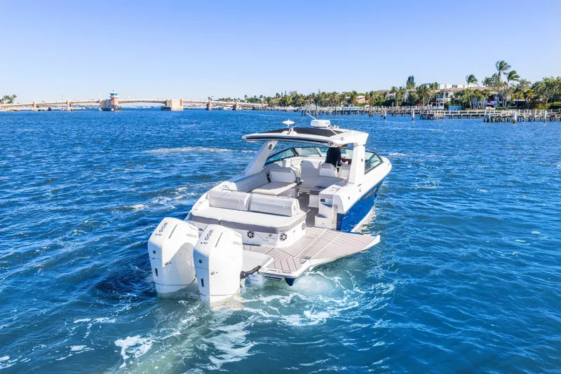 Slide: The Image of 2023 Sea Ray SLX 400 Outboard cruising on a sunny day in a scenic waterway. - 16