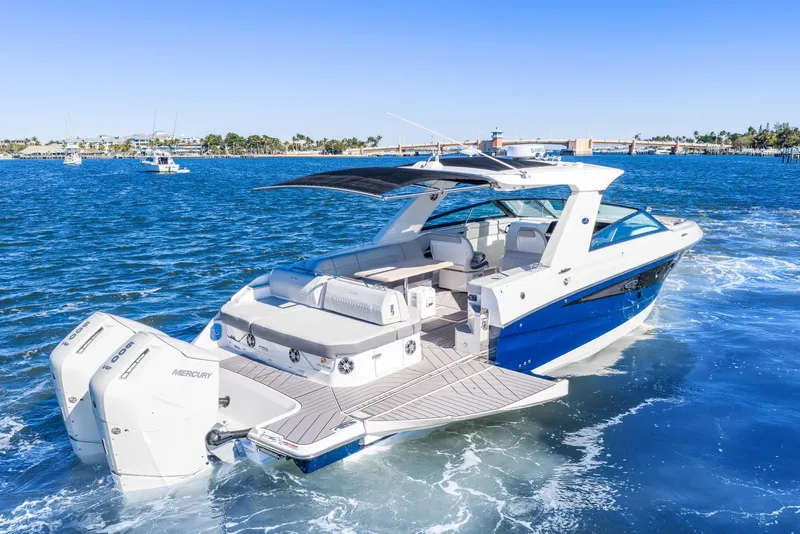 Slide: The Image of 2023 Sea Ray SLX 400 Outboard cruising on blue waters, showcasing luxury and performance. - 2
