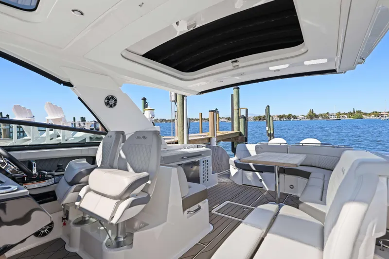 Slide: The Image of Luxurious 2023 Sea Ray SLX 400 Outboard interior with plush seating and scenic waterfront view. - 28