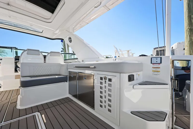 Slide: The Image of 2023 Sea Ray SLX 400 Outboard interior with seating and cabinetry, showcasing luxury design. - 30