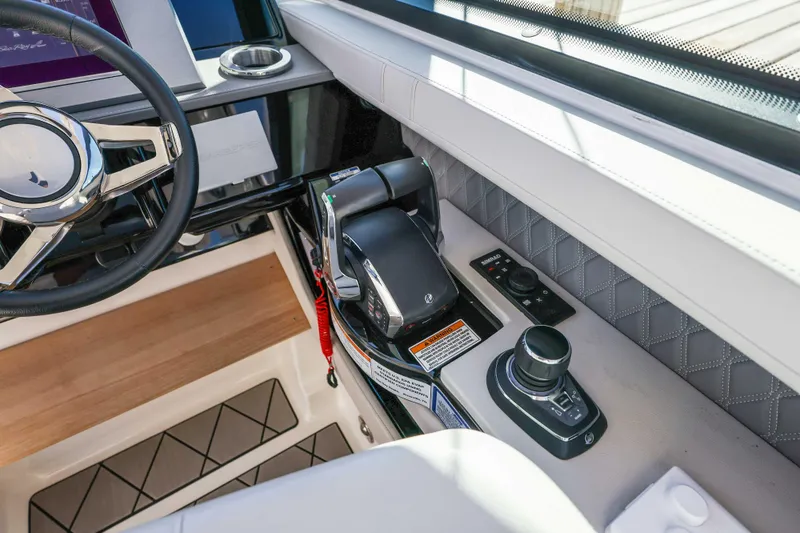 Slide: The Image of 2023 Sea Ray SLX 400 Outboard helm with steering wheel and control panel. - 34