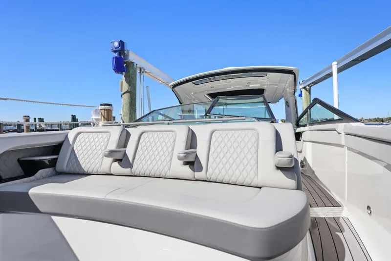 Slide: The Image of 2023 Sea Ray SLX 400 Outboard luxury boat interior with plush seating. - 37
