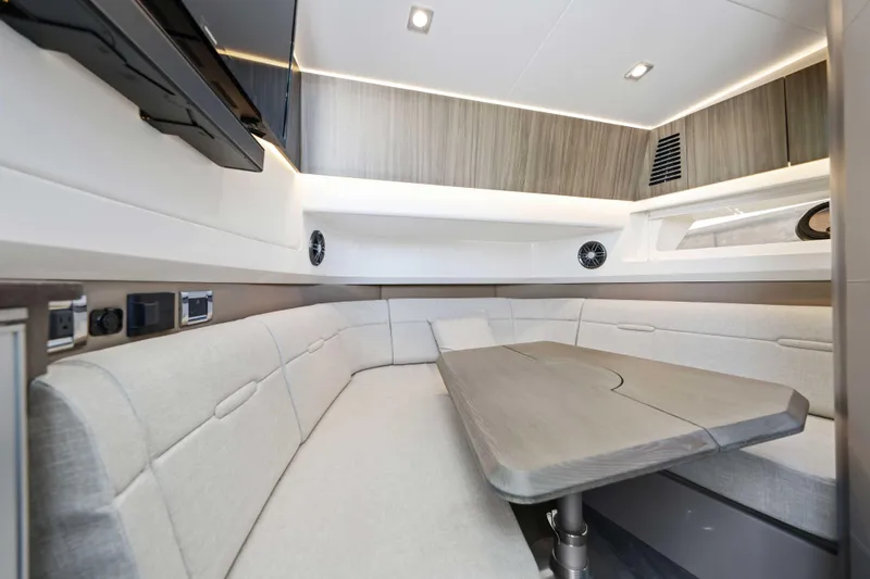 Slide: The Image of Luxurious interior of 2023 Sea Ray SLX 400 Outboard with modern seating and table. - 39