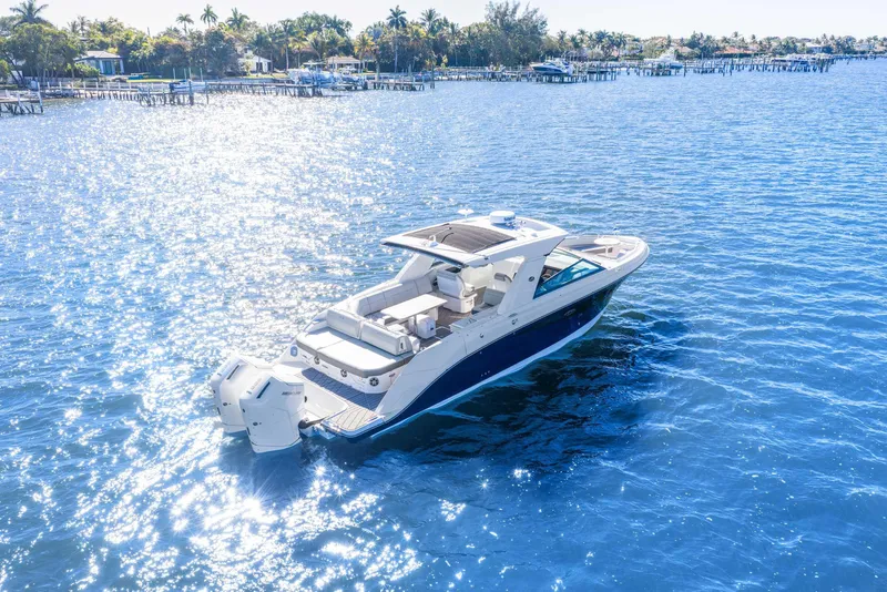 Slide: The Image of 2023 Sea Ray SLX 400 Outboard cruising on sparkling blue water. - 4