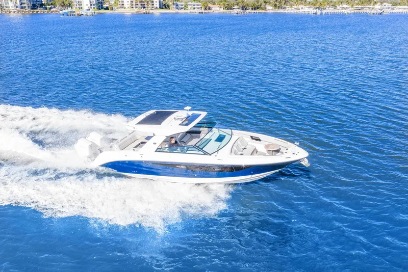 Slide: The Image of 2023 Sea Ray SLX 400 Outboard cruising on blue ocean waters. - 46