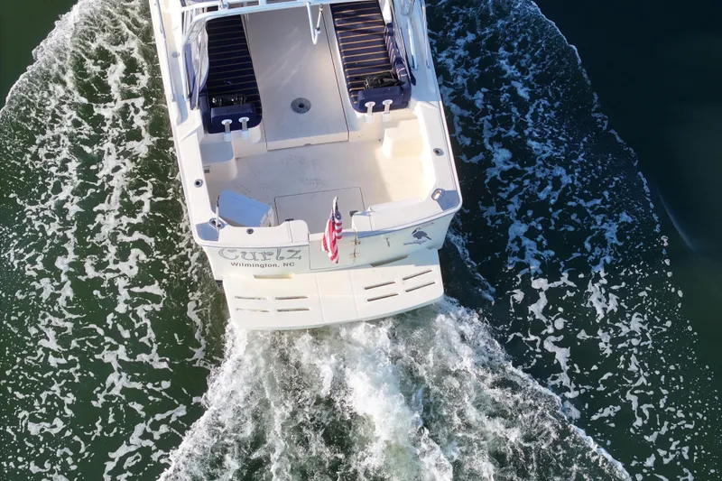 Slide: The Image of Aerial view of 2004 Mainship Pilot 30 Rum Runner cruising on water. - 10