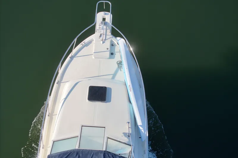 Slide: The Image of Top view of 2004 Mainship Pilot 30 Rum Runner boat on calm water. - 11