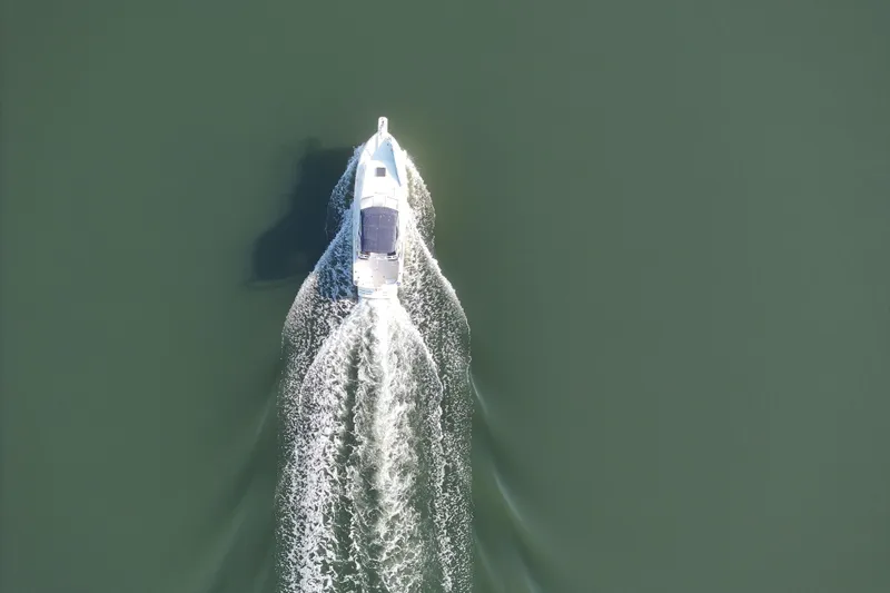 Slide: The Image of Aerial view of 2004 Mainship Pilot 30 Rum Runner cruising on calm water. - 19