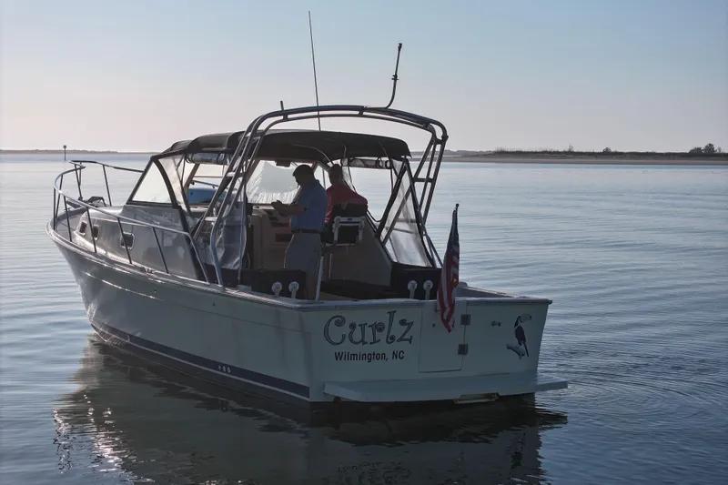 Slide: The Image of 2004 Mainship Pilot 30 Rum Runner boat on calm water, Wilmington, NC. - 3