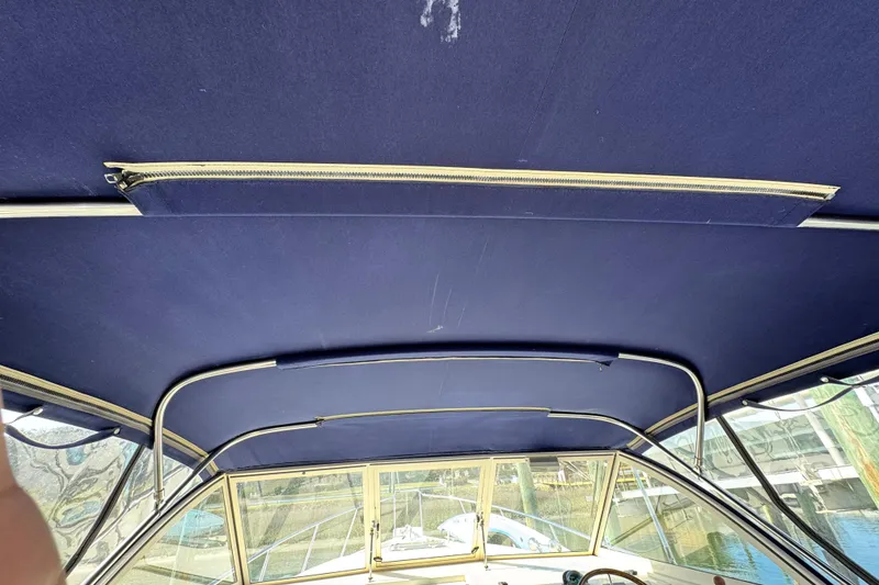 Slide: The Image of 2004 Mainship Pilot 30 Rum Runner boat canopy interior with blue fabric and metal frame. - 30