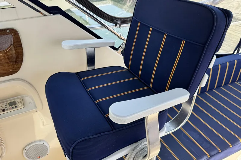 Slide: The Image of Blue-striped seating on 2004 Mainship Pilot 30 Rum Runner boat. - 32