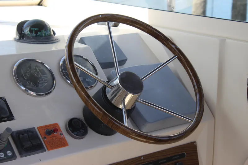 Slide: The Image of Steering wheel and dashboard of 2004 Mainship Pilot 30 Rum Runner boat. - 36