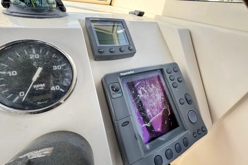 Slide: The Image of Dashboard of a 2004 Mainship Pilot 30 Rum Runner with navigation instruments. - 37