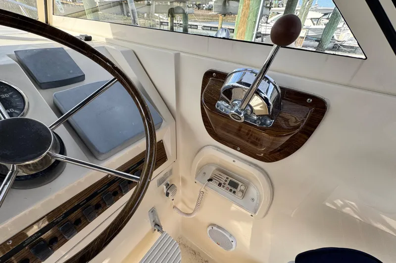 Slide: The Image of 2004 Mainship Pilot 30 Rum Runner helm with steering wheel and throttle controls. - 38