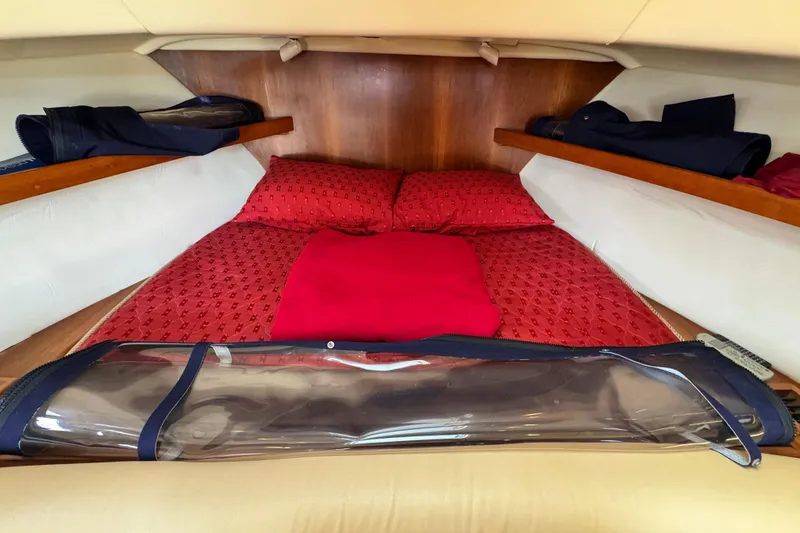 Slide: The Image of Cozy cabin interior of 2004 Mainship Pilot 30 Rum Runner with red bedding. - 41