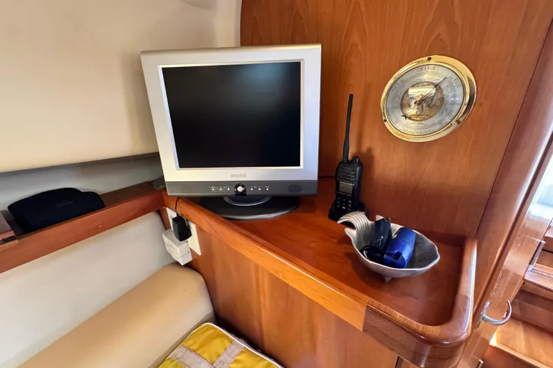 Slide: The Image of 2004 Mainship Pilot 30 Rum Runner cabin with TV, radio, and nautical decor. - 42