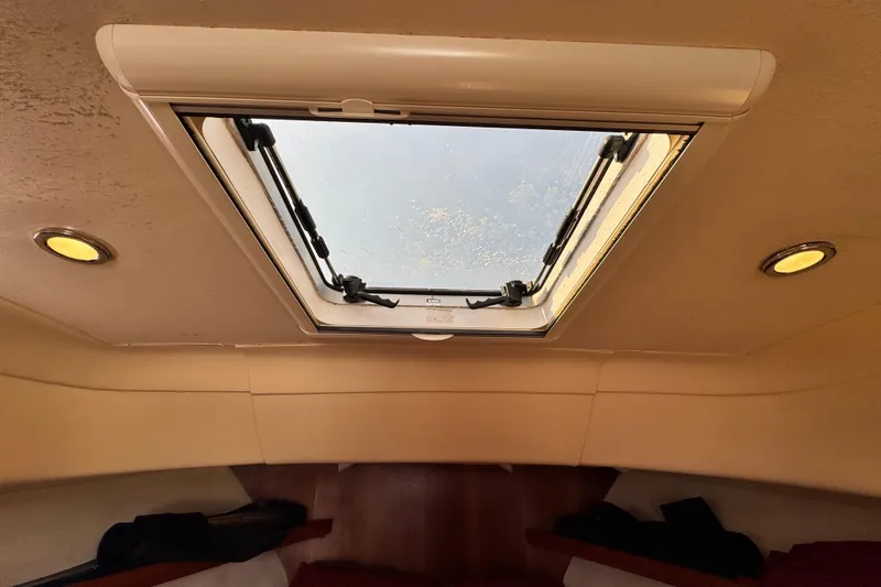 Slide: The Image of Interior cabin view of 2004 Mainship Pilot 30 Rum Runner with skylight and recessed lighting. - 44