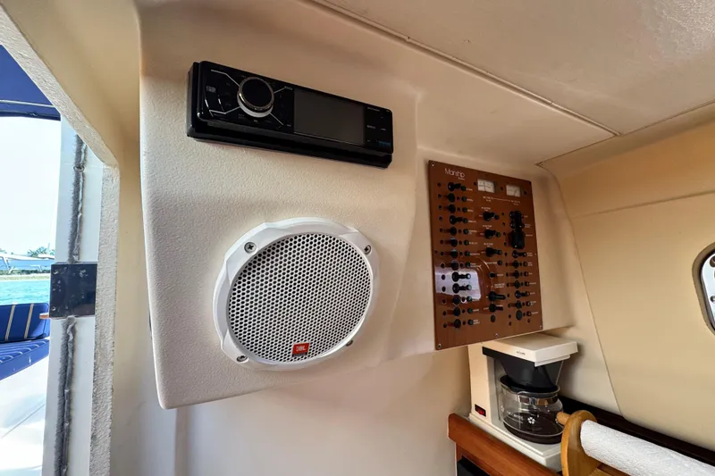 Slide: The Image of Interior of 2004 Mainship Pilot 30 Rum Runner with audio system and control panel. - 46