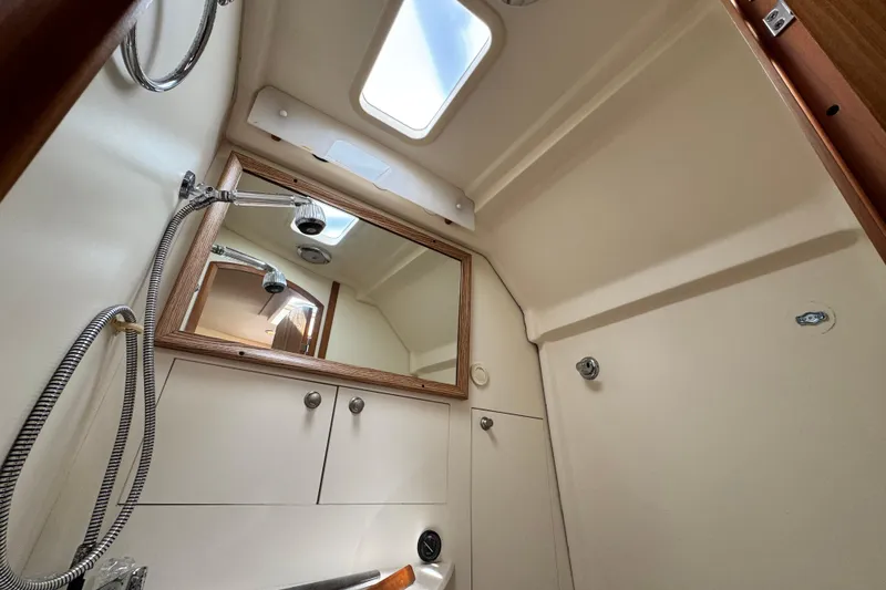 Slide: The Image of 2004 Mainship Pilot 30 Rum Runner boat bathroom with shower and mirror. - 49