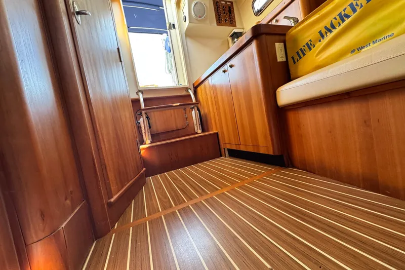 Slide: The Image of Interior of 2004 Mainship Pilot 30 Rum Runner with wood flooring and cabinetry. - 54