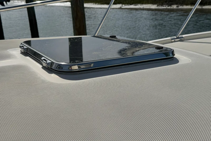 Slide: The Image of 2004 Mainship Pilot 30 Rum Runner hatch detail with water reflections. - 58