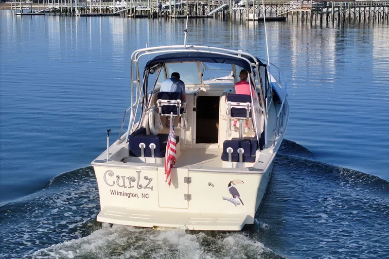 Slide: The Image of 2004 Mainship Pilot 30 Rum Runner boat named "Curlz" cruising in Wilmington, NC waters. - 7