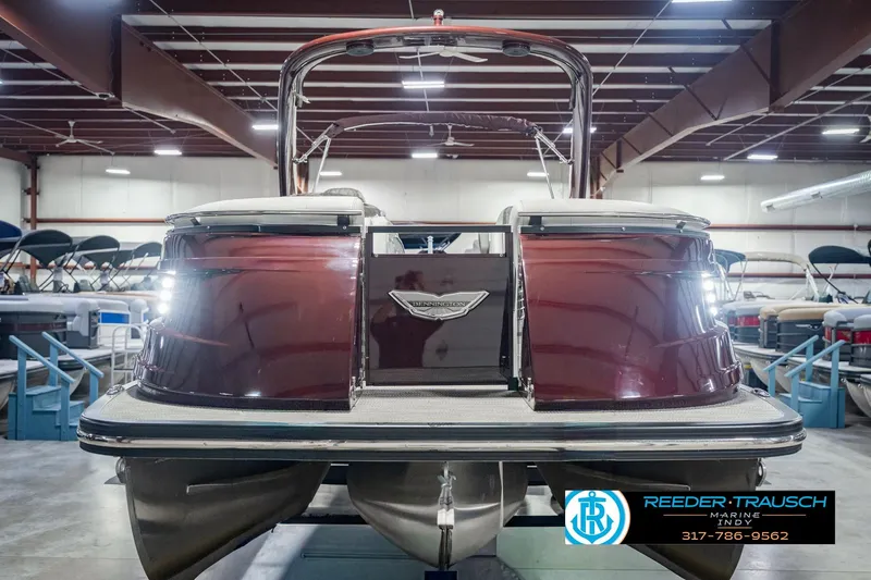 Slide: The Image of 2022 Bennington 23 QXFBA pontoon boat in showroom, rear view. - 2