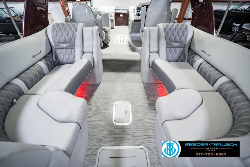 Slide: The Image of Luxurious interior of a 2022 Bennington 23 QXFBA pontoon boat with plush seating. - 21