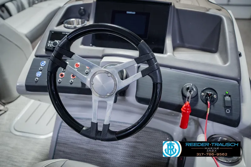 Slide: The Image of Steering console of a 2022 Bennington 23 QXFBA boat with control panel and branding. - 35
