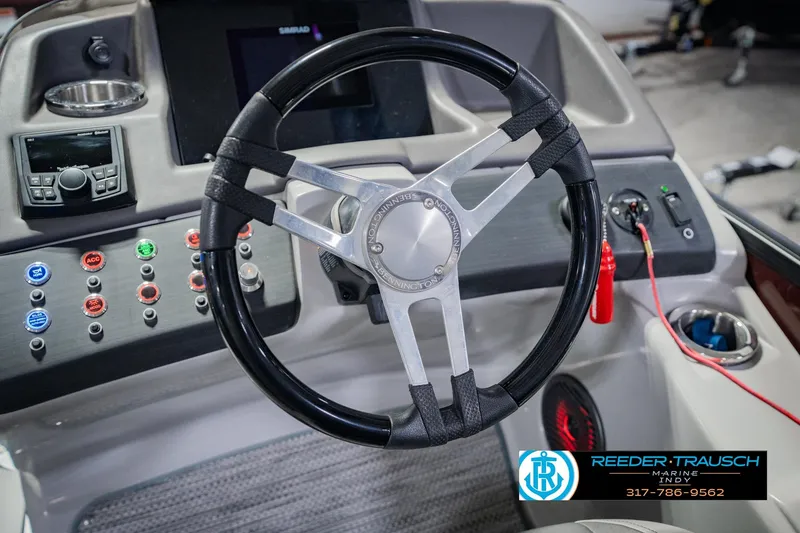 Slide: The Image of Steering wheel and dashboard of a 2022 Bennington 23 QXFBA boat. - 36
