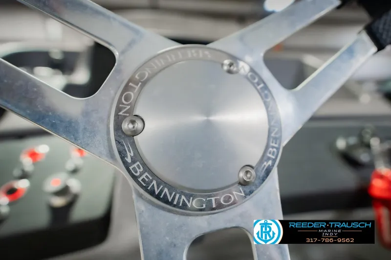 Slide: The Image of Close-up of 2022 Bennington 23 QXFBA steering wheel with logo and controls. - 37