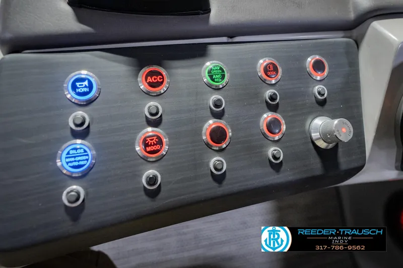 Slide: The Image of Control panel of a 2022 Bennington 23 QXFBA boat with illuminated buttons and switches. - 38
