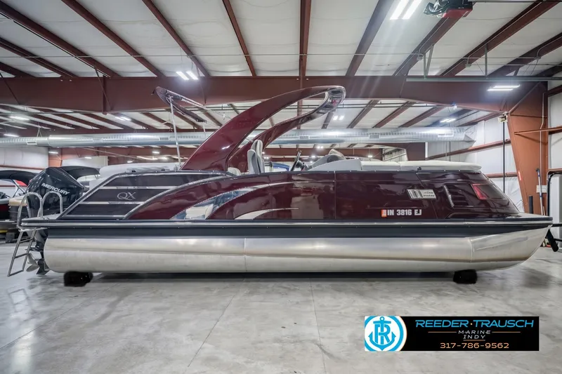 Slide: The Image of 2022 Bennington 23 QXFBA pontoon boat in showroom, side view. - 5