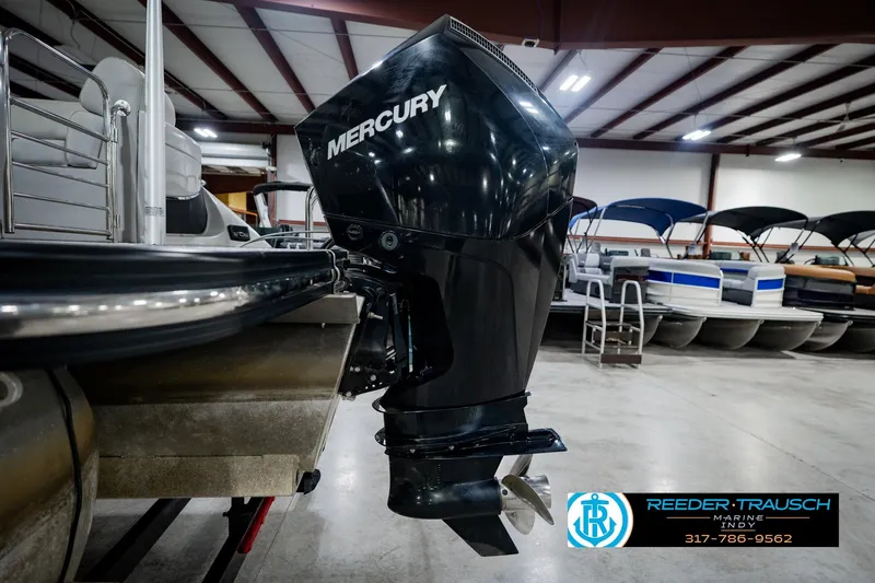 Slide: The Image of 2022 Bennington 23 QXFBA boat with Mercury outboard motor in showroom. - 50