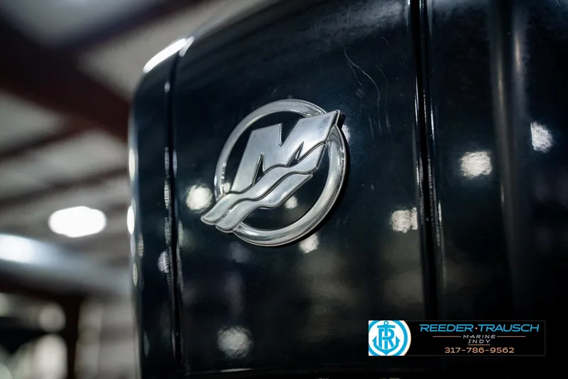Slide: The Image of Close-up of a 2022 Bennington 23 QXFBA boat logo in a showroom setting. - 53