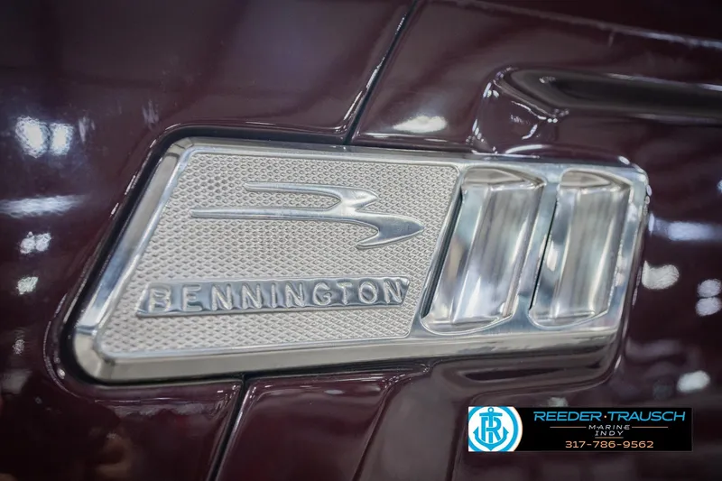 Slide: The Image of Close-up of 2022 Bennington 23 QXFBA logo on maroon surface. - 56