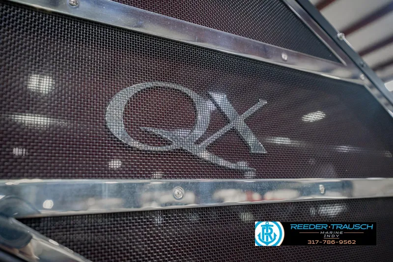 Slide: The Image of 2022 Bennington 23 QXFBA boat grille with QX logo and Reeder-Trausch Marine branding. - 57