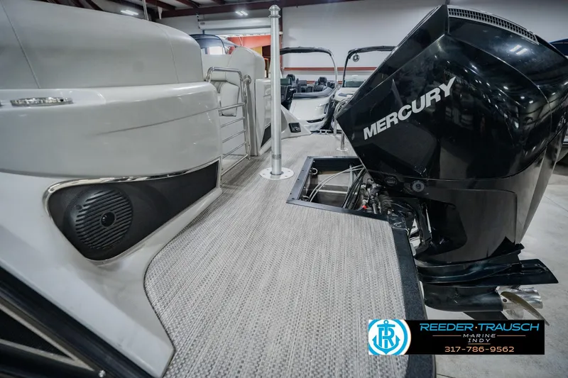 Slide: The Image of 2022 Bennington 23 QXFBA boat with Mercury engine, showcased indoors at Reeder Trausch Marine. - 58