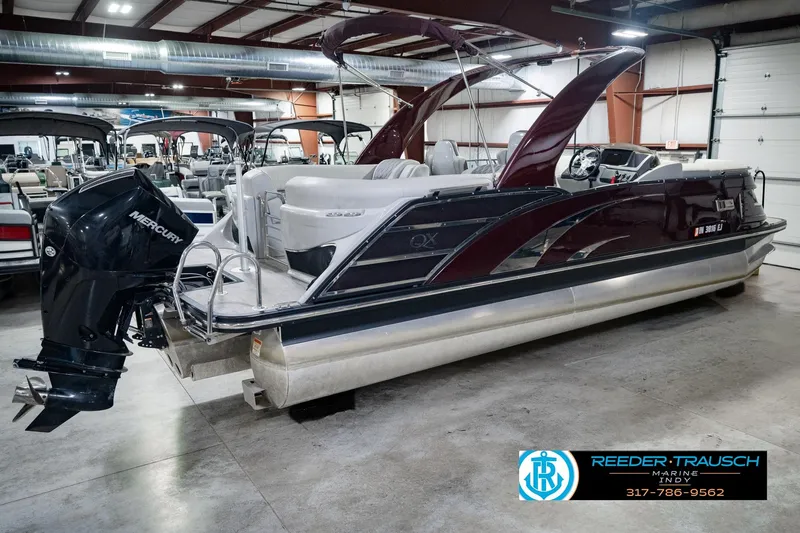 Slide: The Image of 2022 Bennington 23 QXFBA pontoon boat with Mercury engine in showroom. - 6