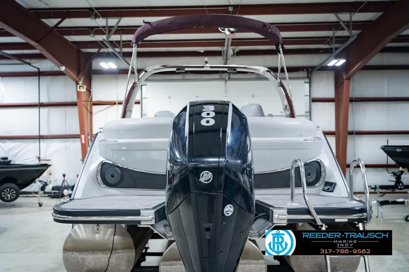 Slide: The Image of 2022 Bennington 23 QXFBA boat with powerful 300 HP engine in indoor showroom. - 8