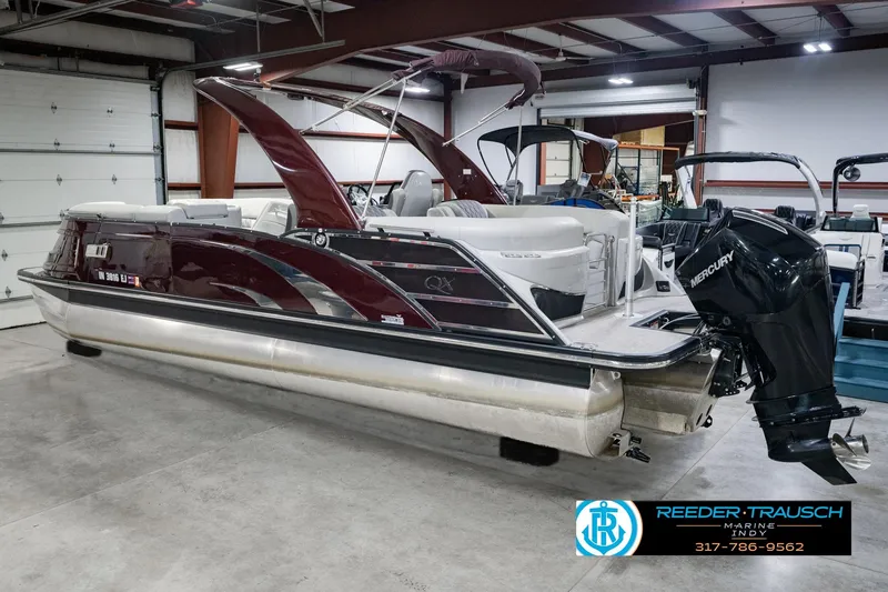 Slide: The Image of 2022 Bennington 23 QXFBA pontoon boat with Mercury engine in showroom. - 9