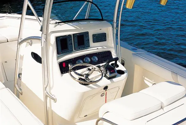 Slide: The Image of 2004 Boston Whaler 270 Outrage boat on stands, featuring Mercury OptiMax engine. - 1