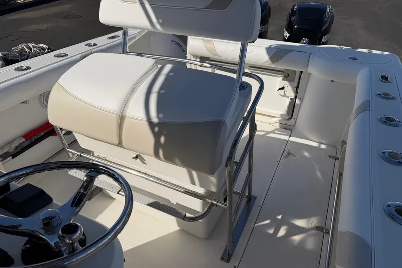 Slide: The Image of 2004 Boston Whaler 270 Outrage boat interior with seating and steering wheel. - 14