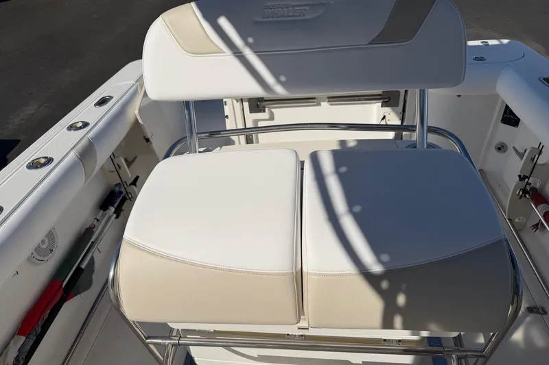 Slide: The Image of Boston Whaler 270 Outrage 2004 boat seating with white cushioned bench and stainless steel frame. - 15