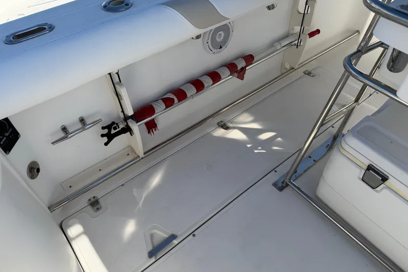 Slide: The Image of 2004 Boston Whaler 270 Outrage boat interior with storage and seating area. - 20