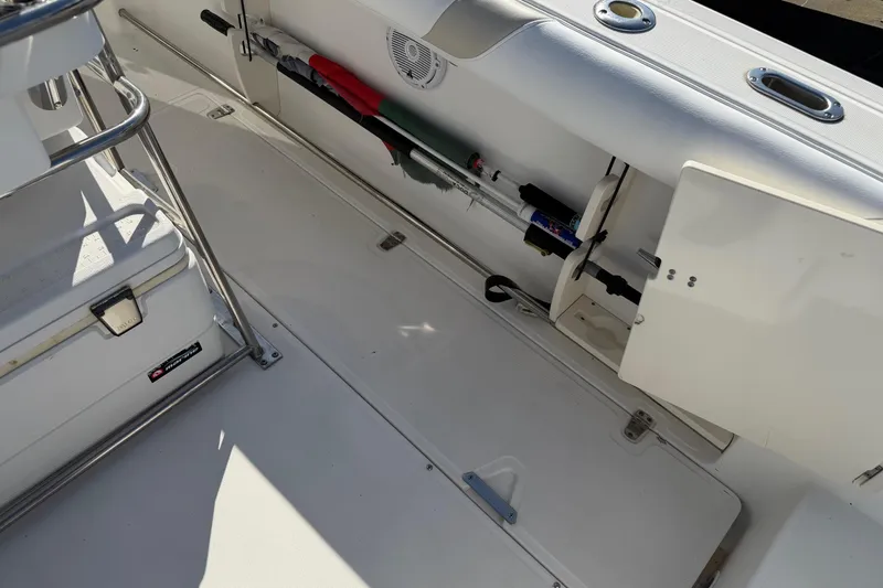 Slide: The Image of 2004 Boston Whaler 270 Outrage interior with storage compartments and fishing rod holders. - 21